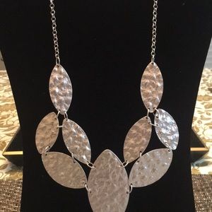 Silver necklace with matching earring.